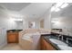 Luxurious bathroom featuring a soaking tub, dual sinks, and granite countertops at 15 Somerset St # 6A, Clearwater Beach, FL 33767