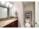 Bathroom with a granite countertop, wood vanity, framed mirror, and a toilet with storage at 15 Somerset St # 6A, Clearwater Beach, FL 33767