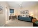 Bedroom featuring a desk, seating area with sleeper sofa, ceiling fan and neutral carpeting at 15 Somerset St # 6A, Clearwater Beach, FL 33767