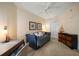 Bedroom with a ceiling fan, sleeper sofa, a desk and dresser, and neutral colored walls at 15 Somerset St # 6A, Clearwater Beach, FL 33767