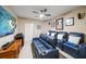 Home theater with reclining seating, movie posters, large screen tv, and ceiling fan at 15 Somerset St # 6A, Clearwater Beach, FL 33767