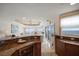 Well-lit open kitchen featuring granite counters, tile floors, and views of the ocean at 15 Somerset St # 6A, Clearwater Beach, FL 33767