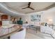 Bright living room featuring a sectional sofa, stylish decor, and a unique ceiling fan at 15 Somerset St # 6A, Clearwater Beach, FL 33767