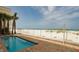Pool beside the beach with palm trees and blue skies in the background at 15 Somerset St # 6A, Clearwater Beach, FL 33767