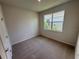Bedroom with neutral carpet and a window offering views of the neighborhood at 18208 Beach Ranch Ter, Lakewood Ranch, FL 34211