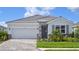Charming one-story home with a stone facade, a two-car garage, and a well-manicured front yard at 18208 Beach Ranch Ter, Lakewood Ranch, FL 34211