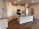 Bright kitchen featuring white cabinets, stainless steel appliances, and an island with granite countertops at 18208 Beach Ranch Ter, Lakewood Ranch, FL 34211