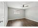 Simple bedroom with dark laminate flooring and ceiling fan at 1601 41St S St, St Petersburg, FL 33711