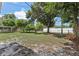 Large backyard with mature trees and grassy area at 1601 41St S St, St Petersburg, FL 33711