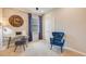 Home office featuring a large clock on a brick wall, a desk, and a blue armchair at 5250 Rosado Run, Lakewood Ranch, FL 34211