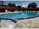 Community pool with lounge chairs and tables at 601 N Hercules Ave # 103, Clearwater, FL 33765