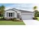 One-story home with gray siding and stone accents at 18208 Beach Ranch Ter, Lakewood Ranch, FL 34211