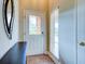 Bright entryway with tiled floor, coat bench, and glass-paned door at 1513 Wharfside Dr # 1513, Tarpon Springs, FL 34689