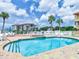 Relaxing community pool and spa with lounge chairs and waterfront view at 1513 Wharfside Dr # 1513, Tarpon Springs, FL 34689