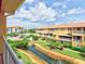 Balcony view of the waterway, landscaping, and neighboring building at 1513 Wharfside Dr # 1513, Tarpon Springs, FL 34689