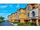 Row of three-story townhouses with attached garages and lush landscaping at 1513 Wharfside Dr # 1513, Tarpon Springs, FL 34689