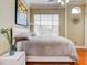 Bright bedroom with king-size bed, wood floors, and large window at 1513 Wharfside Dr # 1513, Tarpon Springs, FL 34689