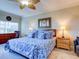 Primary bedroom with king bed, ceiling fan, and blue bedding at 1513 Wharfside Dr # 1513, Tarpon Springs, FL 34689