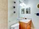 Small bathroom with granite vanity, tiled shower, and glass shelf at 1513 Wharfside Dr # 1513, Tarpon Springs, FL 34689