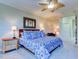 Primary bedroom with king bed, ceiling fan, and blue bedding at 1513 Wharfside Dr # 1513, Tarpon Springs, FL 34689