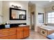 Elegant bathroom with a soaking tub, shower, and granite vanity at 1513 Wharfside Dr # 1513, Tarpon Springs, FL 34689