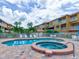 Community pool and spa with lounge chairs at 1513 Wharfside Dr # 1513, Tarpon Springs, FL 34689