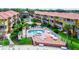 Community pool and patio area with lounge chairs at 1513 Wharfside Dr # 1513, Tarpon Springs, FL 34689