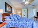 Primary bedroom with king bed, ceiling fan, and blue bedding at 1513 Wharfside Dr # 1513, Tarpon Springs, FL 34689