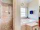Large bathroom with a walk-in shower and a garden tub at 1513 Wharfside Dr # 1513, Tarpon Springs, FL 34689
