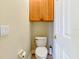 Small bathroom with toilet and overhead storage cabinet at 1513 Wharfside Dr # 1513, Tarpon Springs, FL 34689