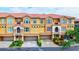 Three-story building with attached garages and landscaping at 1513 Wharfside Dr # 1513, Tarpon Springs, FL 34689