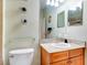 Clean bathroom with wood vanity, granite countertop and a large mirror at 1513 Wharfside Dr # 1513, Tarpon Springs, FL 34689