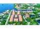 Aerial view of waterfront community with marina, pool, and lush landscaping at 1513 Wharfside Dr # 1513, Tarpon Springs, FL 34689