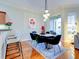 Bright dining room features a modern table with six chairs and hardwood floors at 1513 Wharfside Dr # 1513, Tarpon Springs, FL 34689