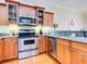 Kitchen with stainless steel appliances and light wood cabinets at 1513 Wharfside Dr # 1513, Tarpon Springs, FL 34689