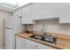 Clean kitchen with white cabinets and butcher block counters at 12760 Indian Rocks Rd # 510, Largo, FL 33774