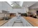 Bright kitchen with white cabinets, wood countertops, and modern appliances at 12760 Indian Rocks Rd # 510, Largo, FL 33774