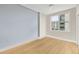 Bright bedroom features wood floors, a modern ceiling fan, and a window with city views at 1120 E Kennedy Blvd # 734, Tampa, FL 33602