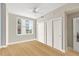 Light-filled bedroom with hardwood floors, ceiling fan, and large closets with sliding doors at 1120 E Kennedy Blvd # 734, Tampa, FL 33602