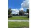 Community basketball and playground surrounded by lush green grass and a black fence at 3201 Dunstable Dr, Land O Lakes, FL 34638