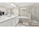 Bathroom with a double vanity, soaking tub, and separate shower at 9782 Coneflower Ct, Land O Lakes, FL 34637