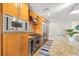 Modern kitchen with stainless steel appliances and wood cabinets at 1120 E Kennedy Blvd # 734, Tampa, FL 33602