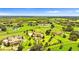 Aerial view of a sprawling property with several houses and a large green field at 10603 Low Oak Ter, Thonotosassa, FL 33592