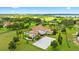 Expansive estate aerial view showcasing lush green landscape, private pool, and a luxurious single-Gathering home at 10603 Low Oak Ter, Thonotosassa, FL 33592