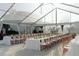 Elegant banquet hall features rectangular tables with white linens and wooden chairs under bright chandeliers at 10603 Low Oak Ter, Thonotosassa, FL 33592