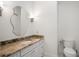 Elegant half bathroom with granite countertops, white cabinetry, and decorative mirror at 10603 Low Oak Ter, Thonotosassa, FL 33592