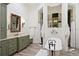 Luxurious bathroom with a freestanding tub, custom vanity, and elegant fixtures at 10603 Low Oak Ter, Thonotosassa, FL 33592