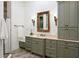 Stylish bathroom with a marble countertop vanity, decorative mirror, and custom cabinetry at 10603 Low Oak Ter, Thonotosassa, FL 33592