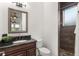 Bathroom with dark vanity, shower, and mosaic tile at 10603 Low Oak Ter, Thonotosassa, FL 33592