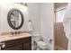 Elegant bathroom with wood vanity, granite countertops, and a walk-in shower at 10603 Low Oak Ter, Thonotosassa, FL 33592